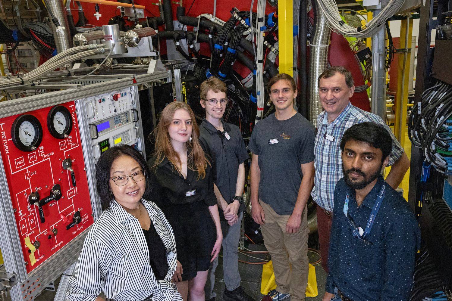 The Hall D detector at Jefferson Lab in Newport News, Virginia, provides an applied learning and research opportunity for students. From left: Liping Gan (UNCW physics professor); undergraduate students Olivia Nippe-Jeakins (George Washington University), Shane Whaley (UNCW), Ben Simpson (UNCW); Alexander “Sasha” Somov (Jefferson Lab Hall D staff scientist); and Laveen Puthiya Veetil (UNCW postdoctoral scholar). 
