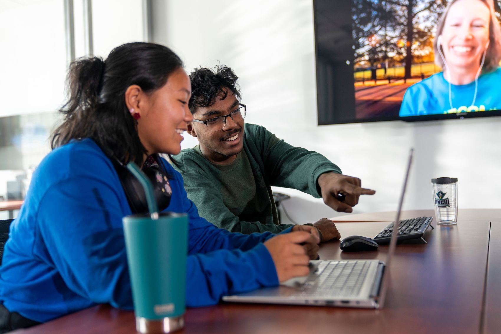 Two students working on a lap top in Discovery Hall on the UNCW campus.
